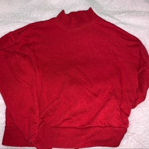 A red turtle neck long sleeved shirt